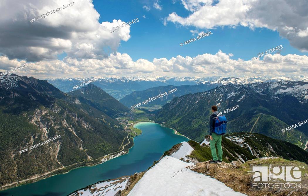 Stock Photo: Hiker on hiking trail, crossing from the Seekarspitz to the Seebergspitz, view over the lake Achensee, Tyrol, Austria.