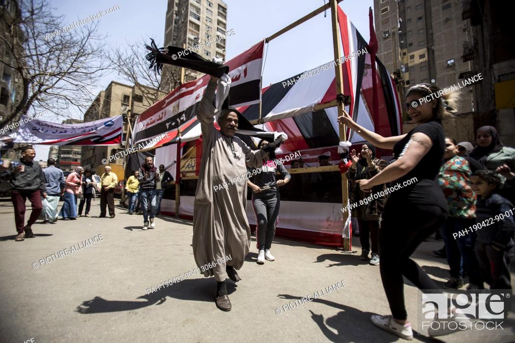 Stock Photo: 22 April 2019, Egypt, Cairo: Voters sing and dance outside a polling station during the third and last day of the national referendum on the constitutional.