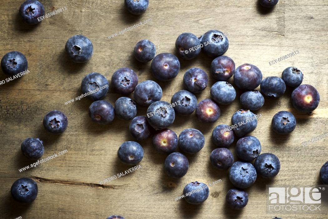 Stock Photo: Close up of a blueberries ion a wood table.