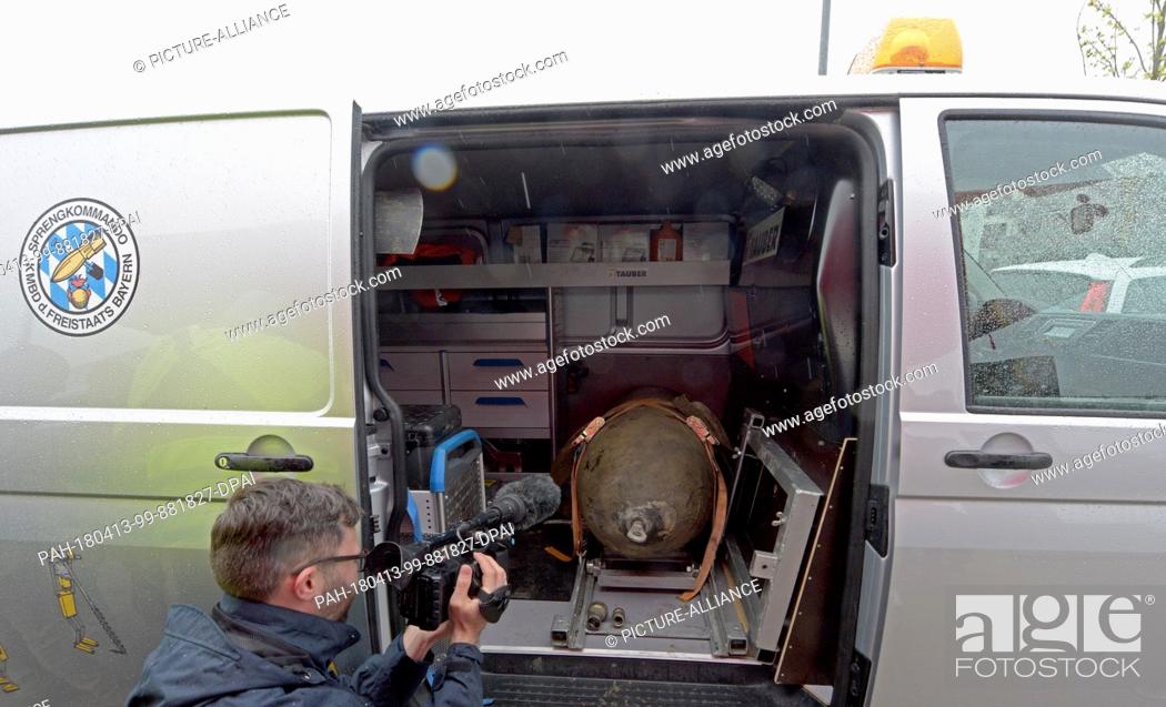 Stock Photo: 13 April 2018, Germany, Neu-Ulm: A defused World War II aircraft bomb lies tied down in the back of a van. The bomb was found during constructzion work in the.