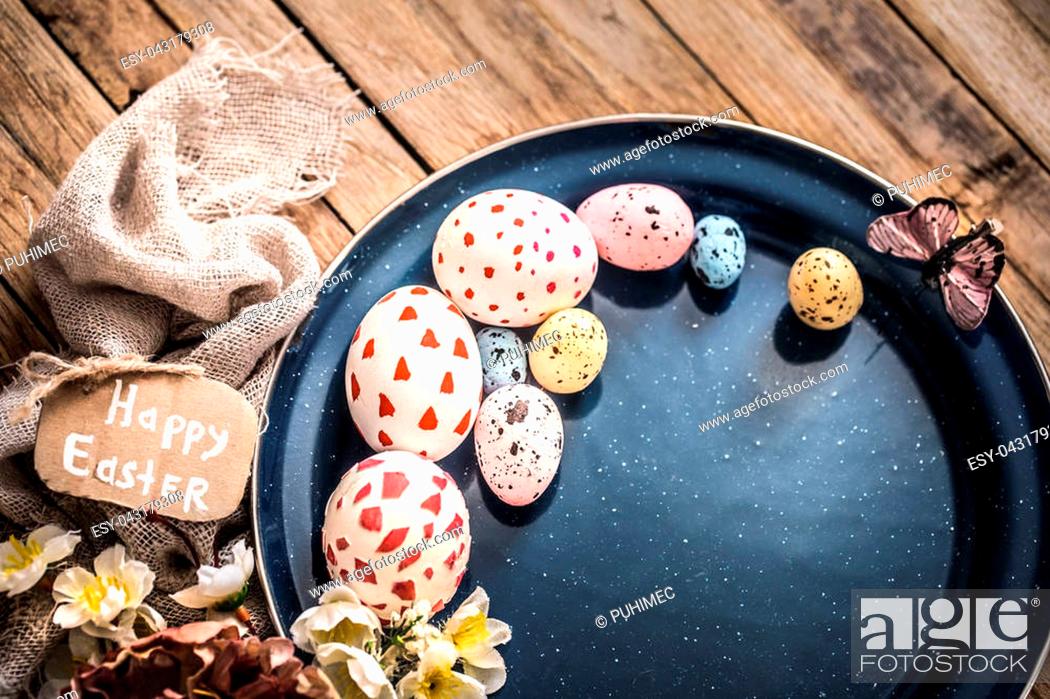 Stock Photo: Easter eggs on a plate, the concept of Easter holidays.