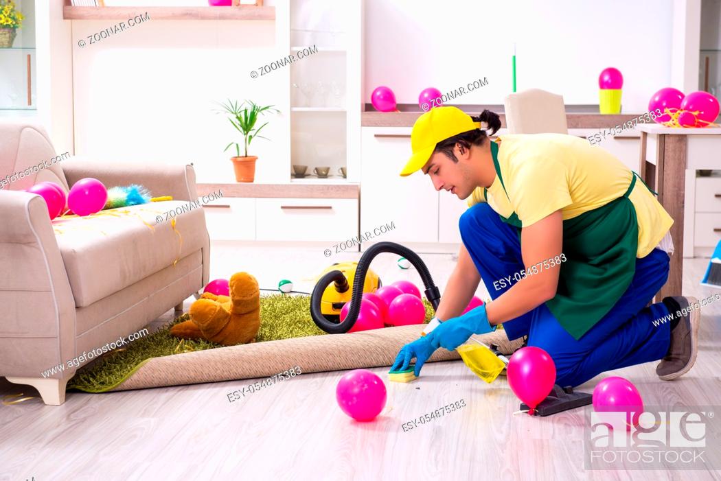 Stock Photo: The young male contractor doing housework after party.