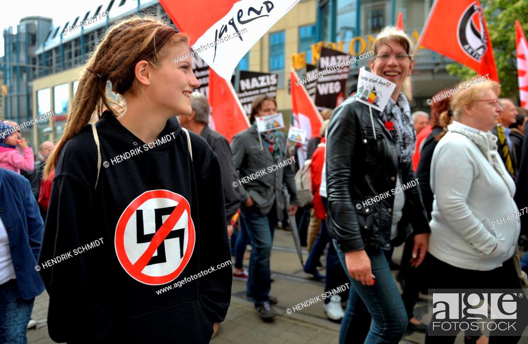 Stock Photo: A woman with a crossed-out swastika on her chest takes part in a May Day rally in Plauen, Germany, 01 May 2014. Protests and demonstrations are being held all.