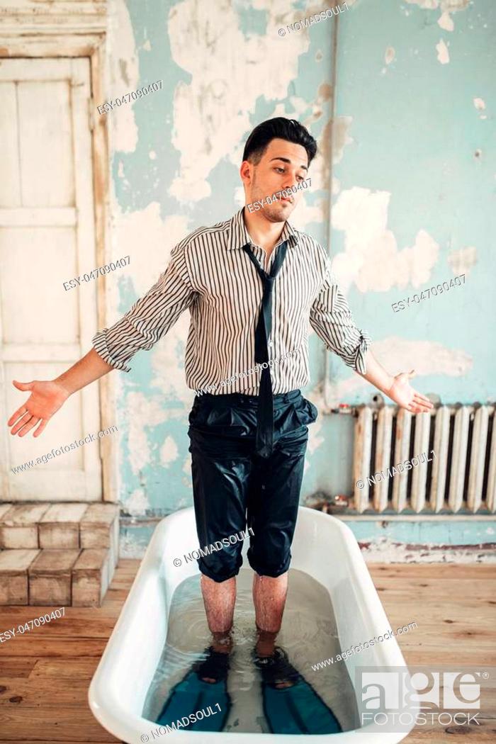 Stock Photo: Beginning businessman in flippers standing in bath, humor. Business lottery or fortune concept.