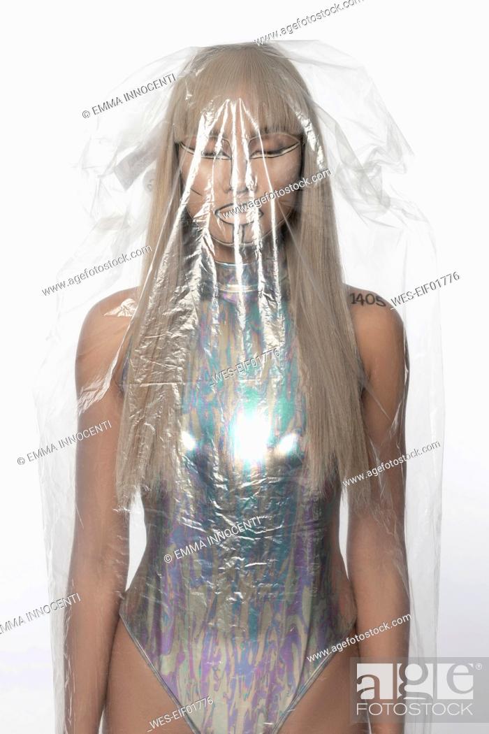 Stock Photo: Cyborg woman with silver bodysuit covered in plastic against white background.