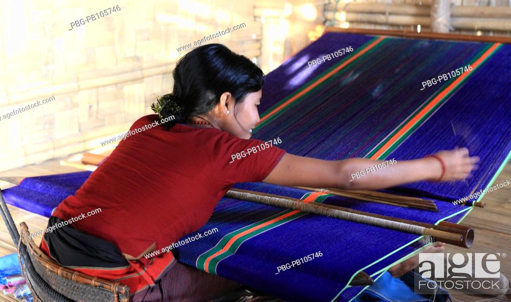 Stock Photo: A Marma tribal woman weaving cloth on traditional handloom Bandarban, Bangladesh December 2009.