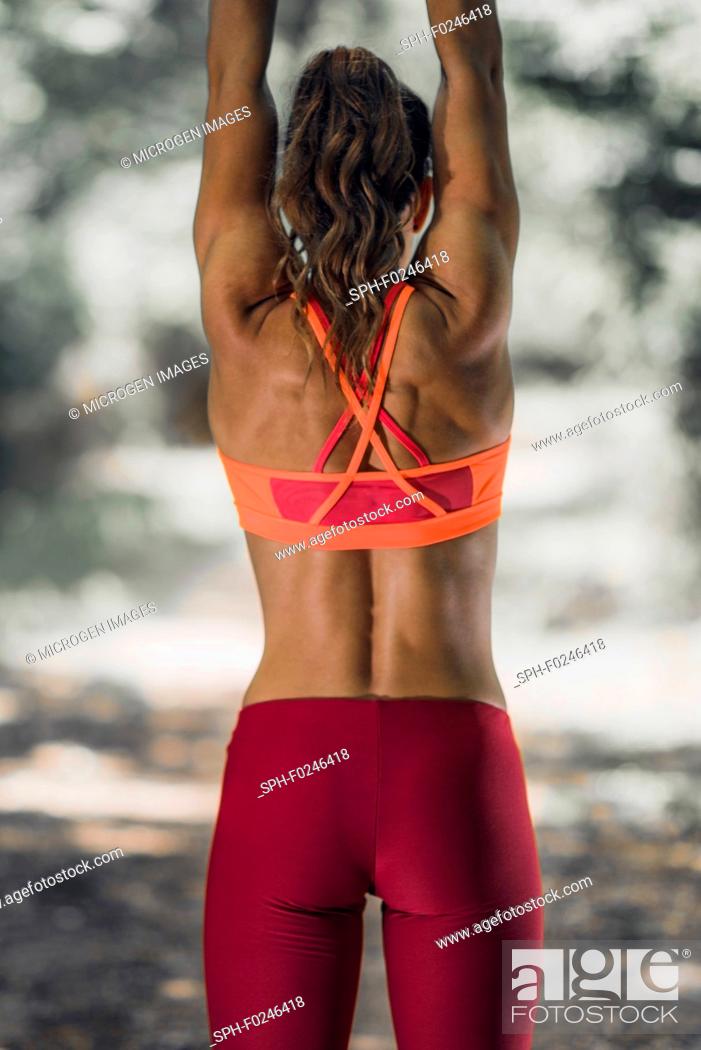 Stock Photo: Outdoor exercising. Female athlete exercising with kettlebell in the park.