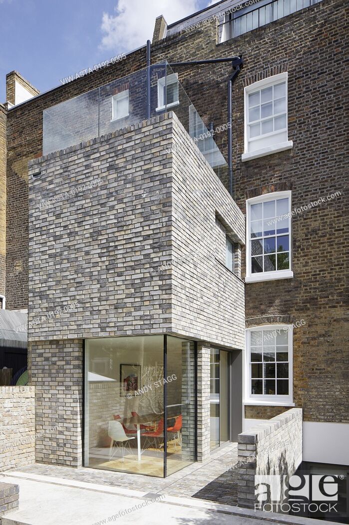 Stock Photo: Oblique view of double-height rear extension with corner window on ground level. Queens House, London, United Kingdom. Architect: Paul Archer Design -.