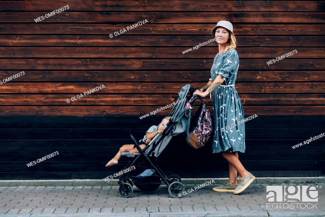 skuffe mængde af salg Sprængstoffer Mid adult woman pushing baby stroller on footpath, Stock Photo, Picture And  Royalty Free Image. Pic. WES-OMIF00073 | agefotostock