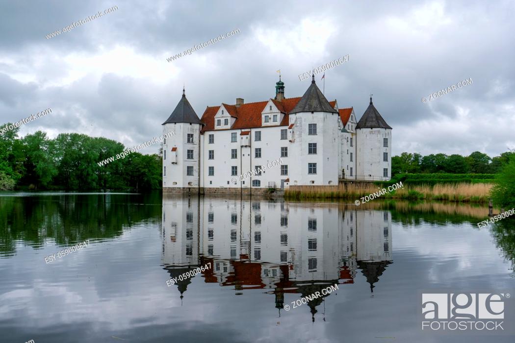 Stock Photo: Gluecksburg, Germany - 27 May, 2021: view of the Gluecksburg castle in northern Germany with beautiful reflections in the lake.