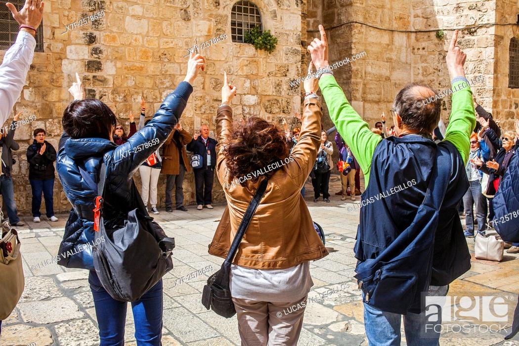 Stock Photo: Pilgrims following Jesus' steps on the Via Dolorosa, in exterior of Church of the Holy Sepulchre also called the Church of the Resurrection, Christian Quarter.