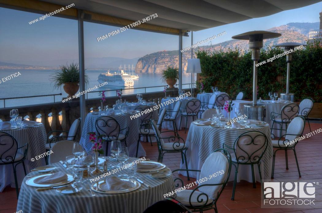 Stock Photo: Empty tables and chairs at a restaurant on the terrace of a hotel, Sorrento, Campania, Italy.