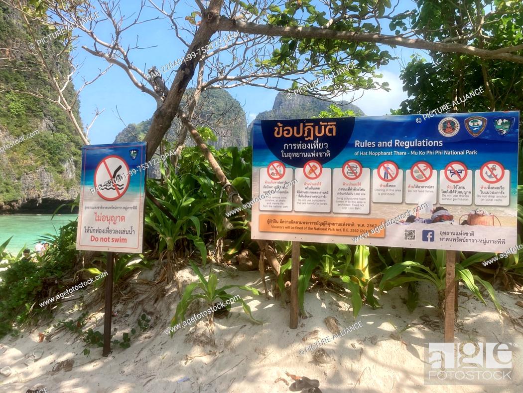 Stock Photo: PRODUCTION - 12 March 2022, Thailand, Ko Phi Phi Leh: Signs read the new rules after the reopening of Maya Bay. The rules for visiting the dream beach in.