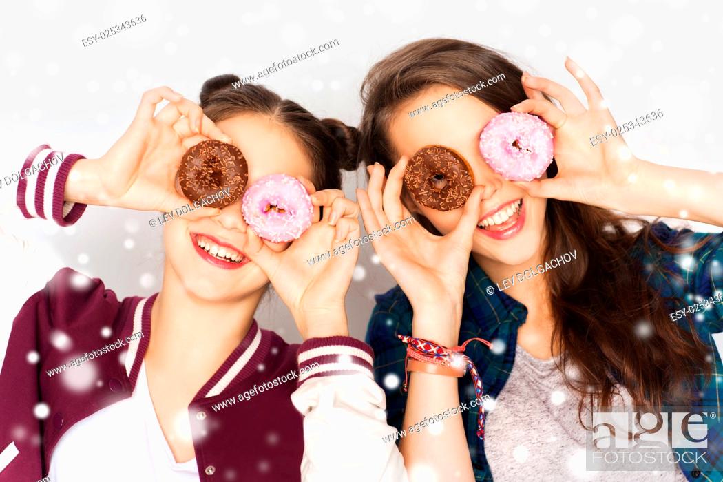 Stock Photo: winter, christmas, people, holidays and fast food concept - happy smiling pretty teenage girls or friends with donuts making faces and having fun over gray.