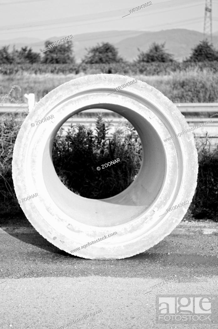 Stock Photo: Concrete pipe at the construction site in black and white.