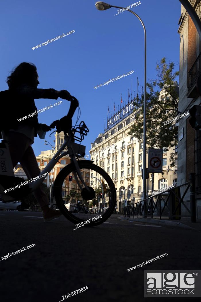 Stock Photo: cyclist silhouette in neptuno square with the palace hotel. madrid. spain.