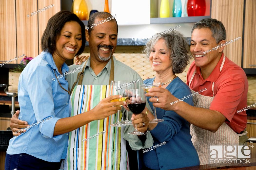 Stock Photo: Multi-ethnic friends toasting with wine.