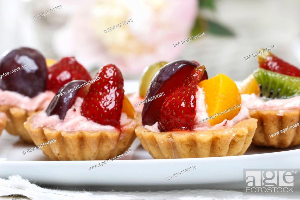 Stock Photo: Colorful cupcakes - party dessert. White table setting.