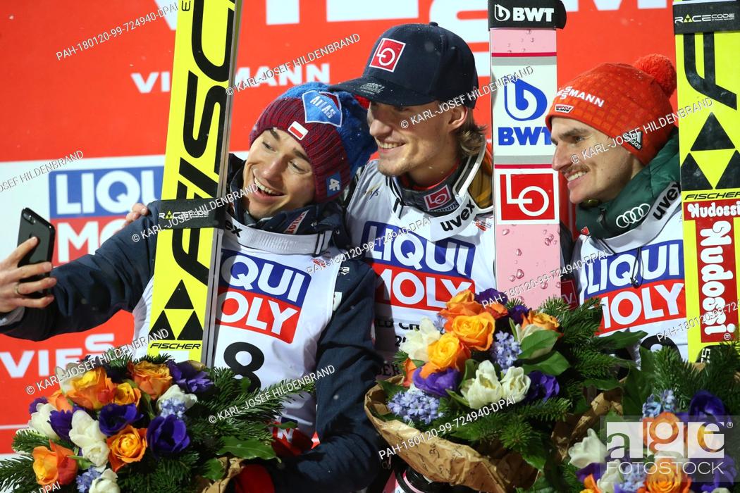 Stock Photo: Kamil Stoch of Poland (Silver - l-r) takes a selfie with Daniel Andre Tande of Norway (Gold) and Richard Freitag of Germany (Bronze) on the podium at the.