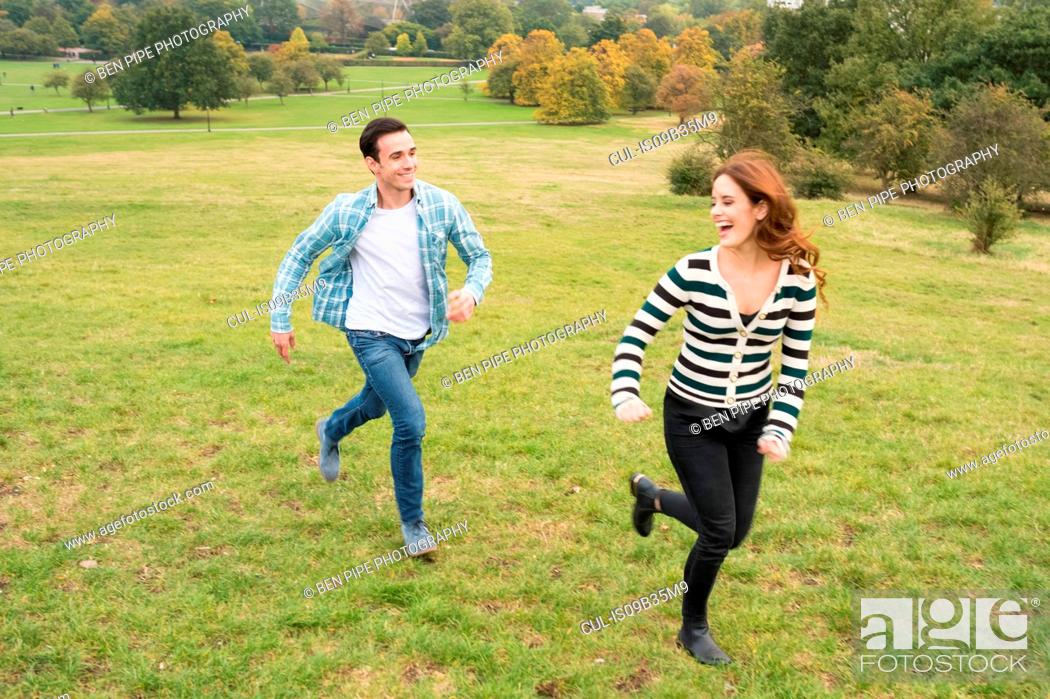 Stock Photo: Couple running in field.