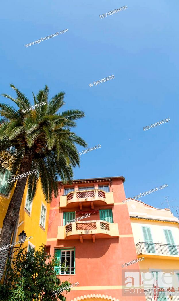 Stock Photo: Colorful plaster buildings in the south of France with a Tobac sign.