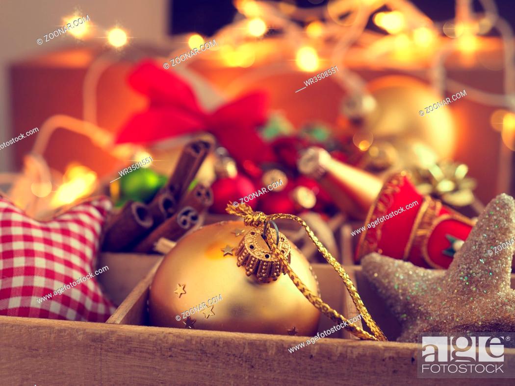 Stock Photo: Colorful Christmas decoration items in a wooden box, close up with the selective focus on foreground.