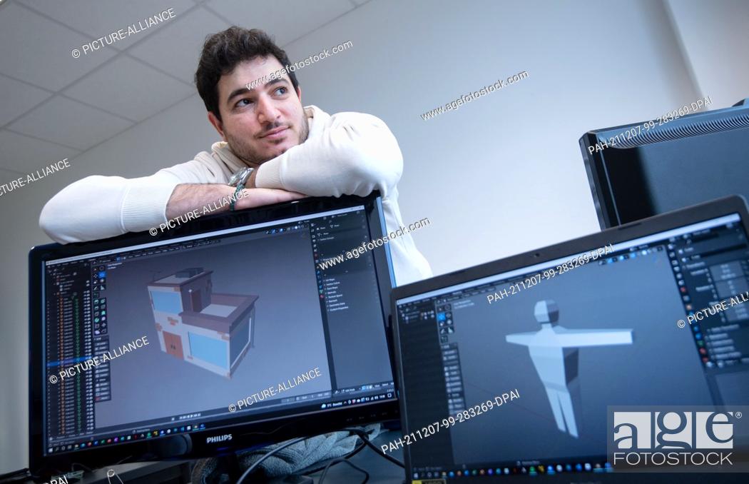 Stock Photo: PRODUCTION - 19 November 2021, Baden-Wuerttemberg, Ludwigsburg: Rawand Ahmad, computer game developer, sits behind computer monitors showing a modelled house.