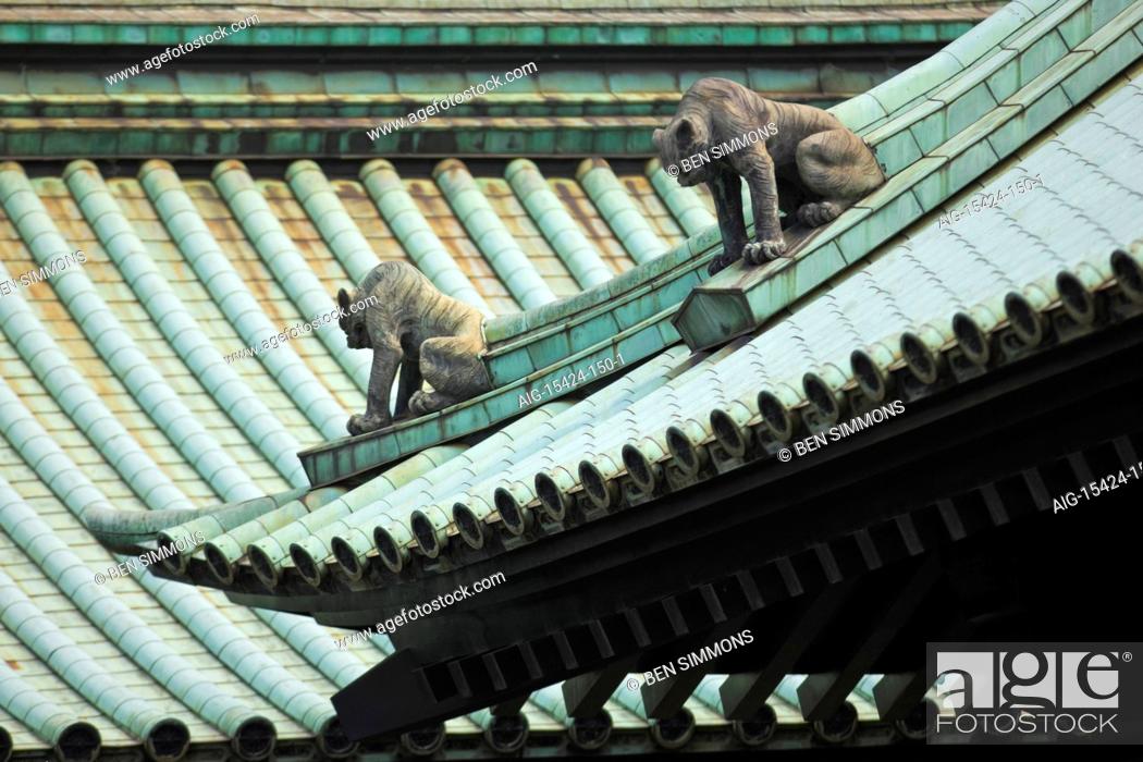 Stock Photo: The complex roof design is watched over by komainu lion-dog guardian statues at Yushima-Seido Temple in the old downtown Kanda District of Tokyo, Japan.