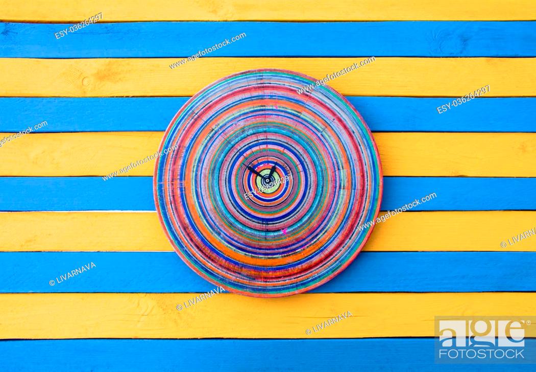 Stock Photo: Vintage creative clock blue and yellow striped wood texture surface. Bright colors show time.
