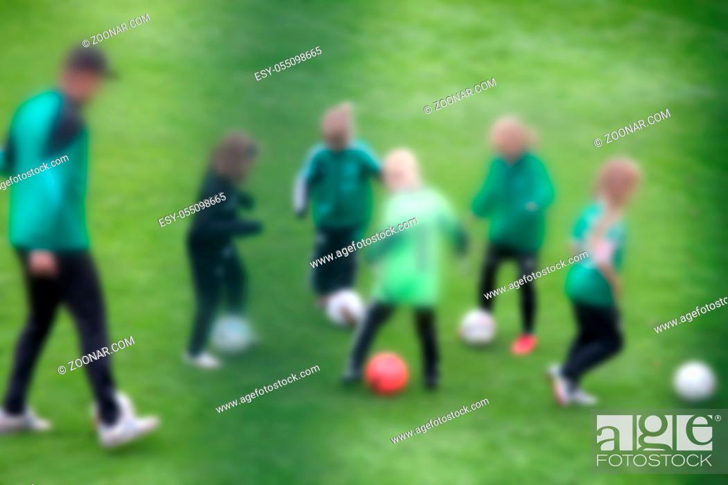 Stock Photo: People are strong blurred anonymous. Football on field for boys team.
