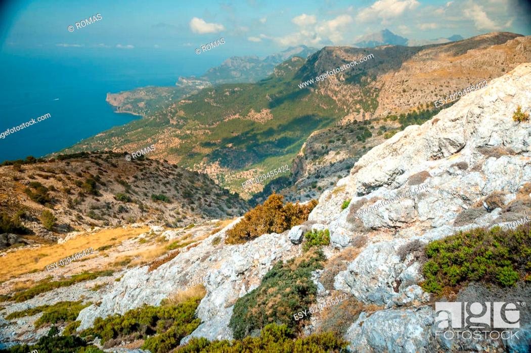 Stock Photo: Beautiful landscape view of rocky mountains and clouds on the western part of Mallorca island, Spain. Tramuntana mountains with blue sea in background.