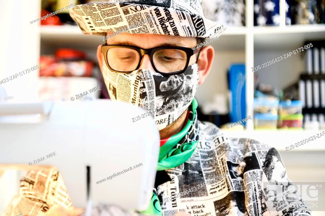 Stock Photo: April 23, 2020, Berlin, Berlin, Germany: Italian hatter GIUSEPPE TELLA can be ssen waering a face masks behind a sewing machine in his studio in Berlin.