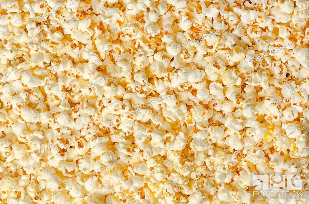 Stock Photo: Popcorn, popped corn, surface and background. Butterfly shaped popcorn puffed up from the kernels, after it has been heated.