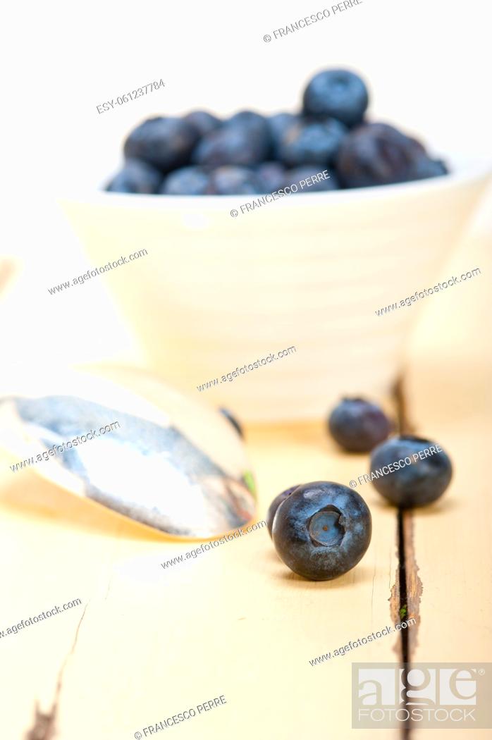 Stock Photo: fresh blueberry on a bowl with silver spoon over wood table.