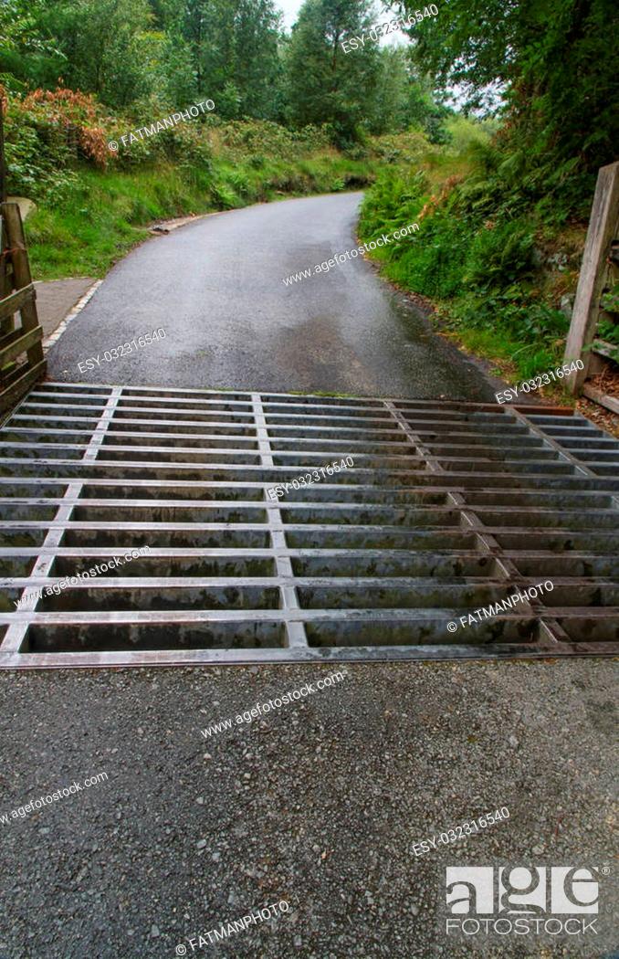 Stock Photo: Cattle grid, stock grid, cattle guard, vehicle pass, Texas gate, stock gap or cattle stop. On track that is part of the Llanberis path up Snowdon.