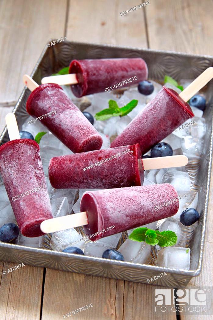 Stock Photo: Delicious blueberry sorbet ice cream popsicles with berries.