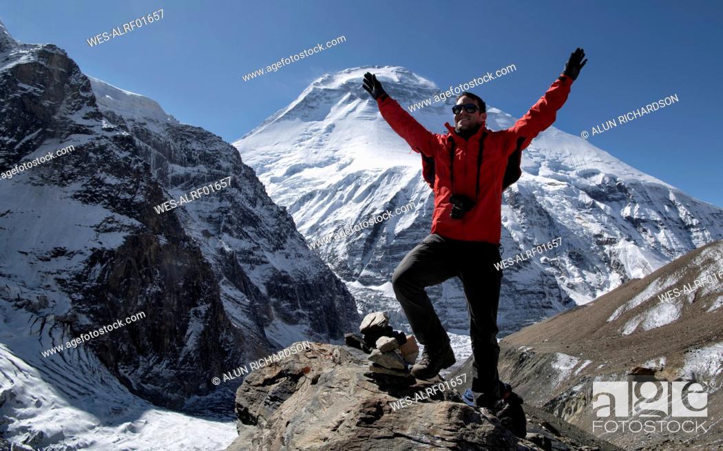 Stock Photo: Mountaineer cheering on top of French Pass, Dhaulagiri Circuit Trek, Himalaya, Nepal.