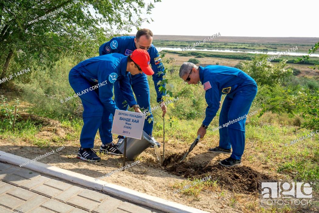 Stock Photo: At the Cosmonaut Hotel crew quarters in Baikonur, Kazakhstan, Expedition 53-54 crewmember Mark Vande Hei of NASA (right) plants a tree bearing his name Sept.