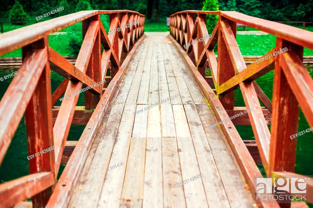 Stock Photo: Old Red Rustic Wooden Bridge Over Pond Background.