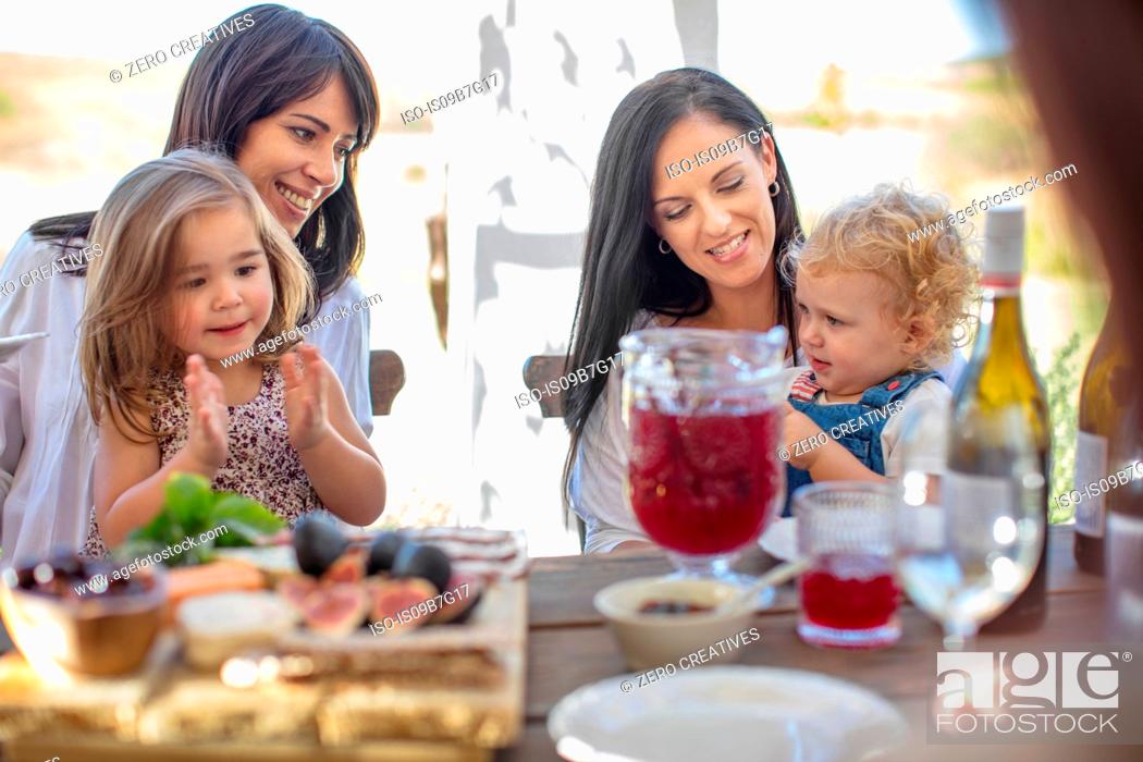 Stock Photo: Children at family lunch outdoors.