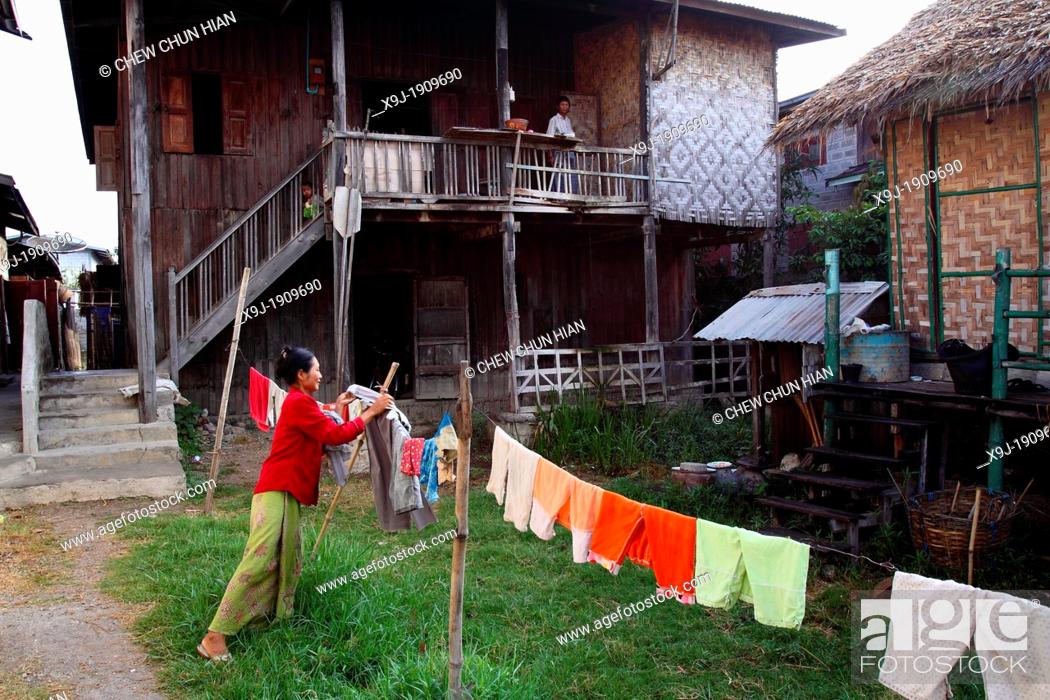 Stock Photo: Burmese Woman hanging up laundry, Inle Lake, Shan states, Burma.