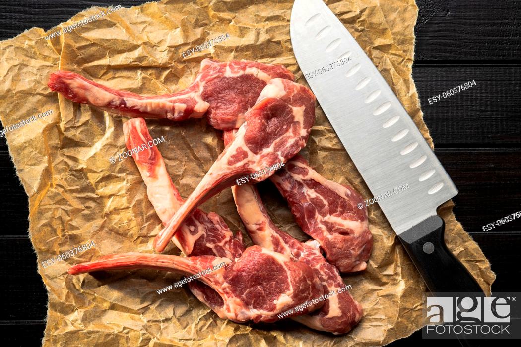 Stock Photo: Slices raw lamb chops on baking paper. Top view.