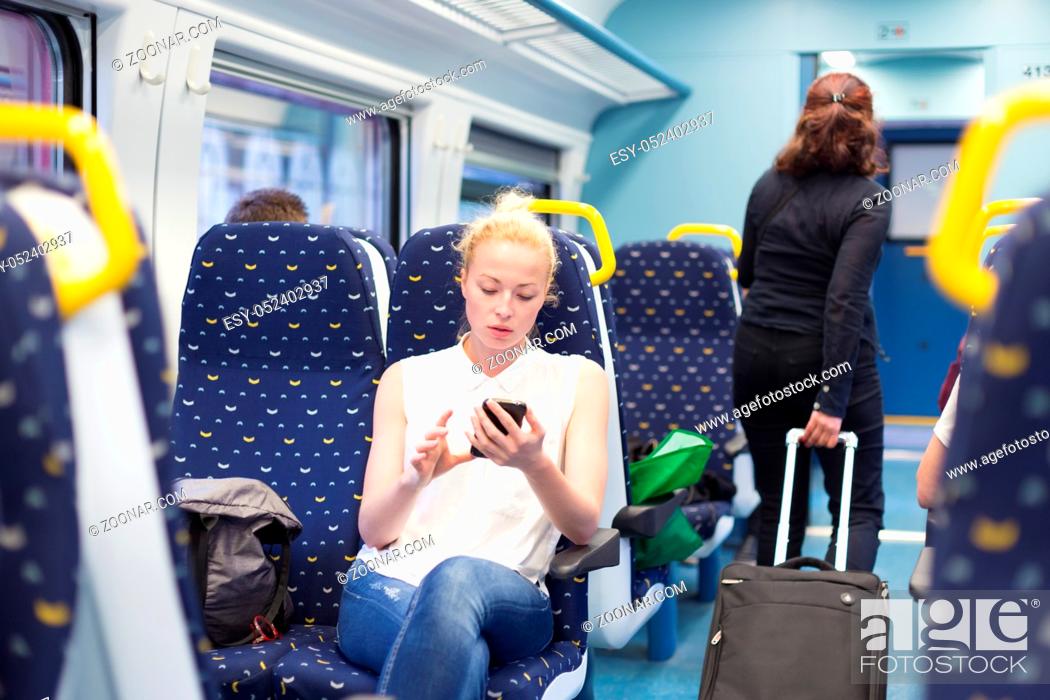 Stock Photo: Woman workin on smart phone while traveling by train. Business travel concept.