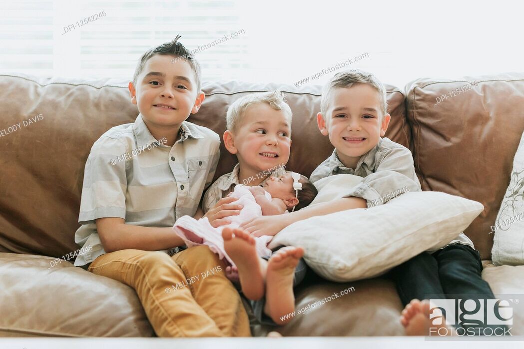 Stock Photo: Three young boys with their newborn baby sister; Surrey, British Columbia, Canada.