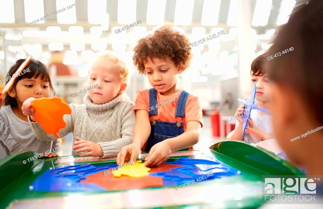 Stock Photo: Kids playing at interactive exhibit in science center.