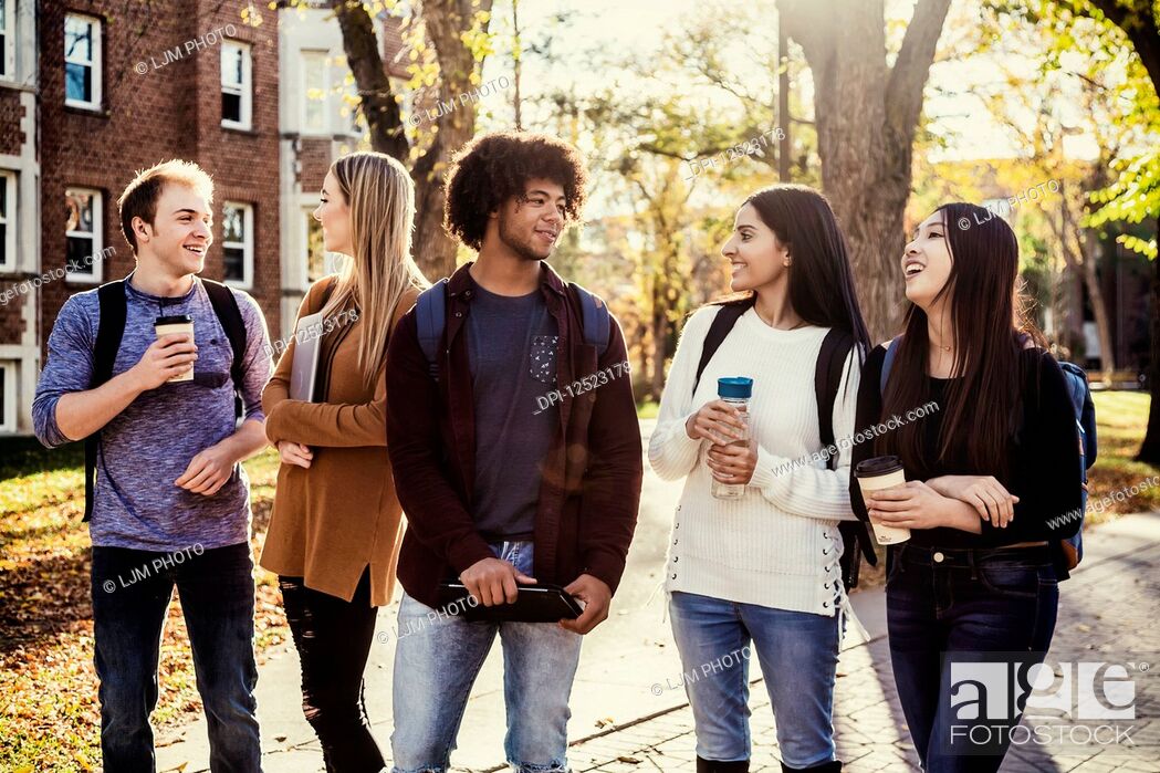 Stock Photo: An ethnically diverse group of university students walk and talk together on the campus in autumn; Edmonton, Alberta, Canada.