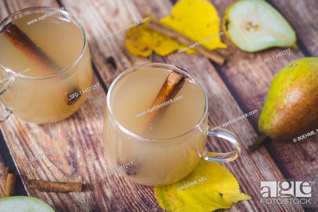 Stock Photo: Pear cider with cinnamon sticks.