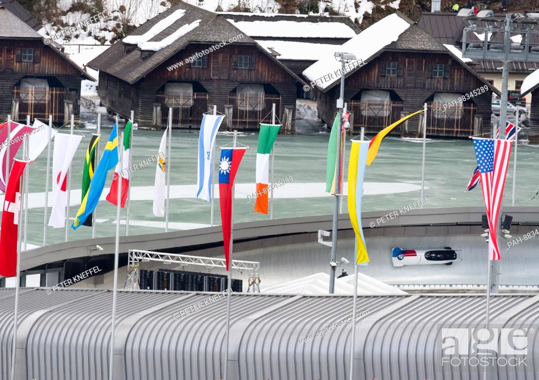 Stock Photo: The four-person Bob with Steven Holcomb, Carlo Valdes, James Reed und Samuel McGuffie from the USA on the echo-curve lined with flags in Schoenau Am Koenigssee.