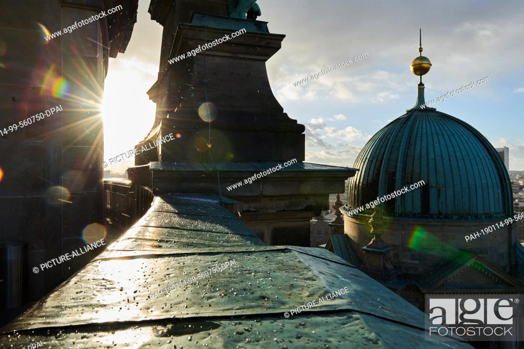 Stock Photo: 14 January 2019, Berlin: The view from the Berlin Cathedral in Berlin Mitte. The wet roofs of the cathedral reflect the sunlight.