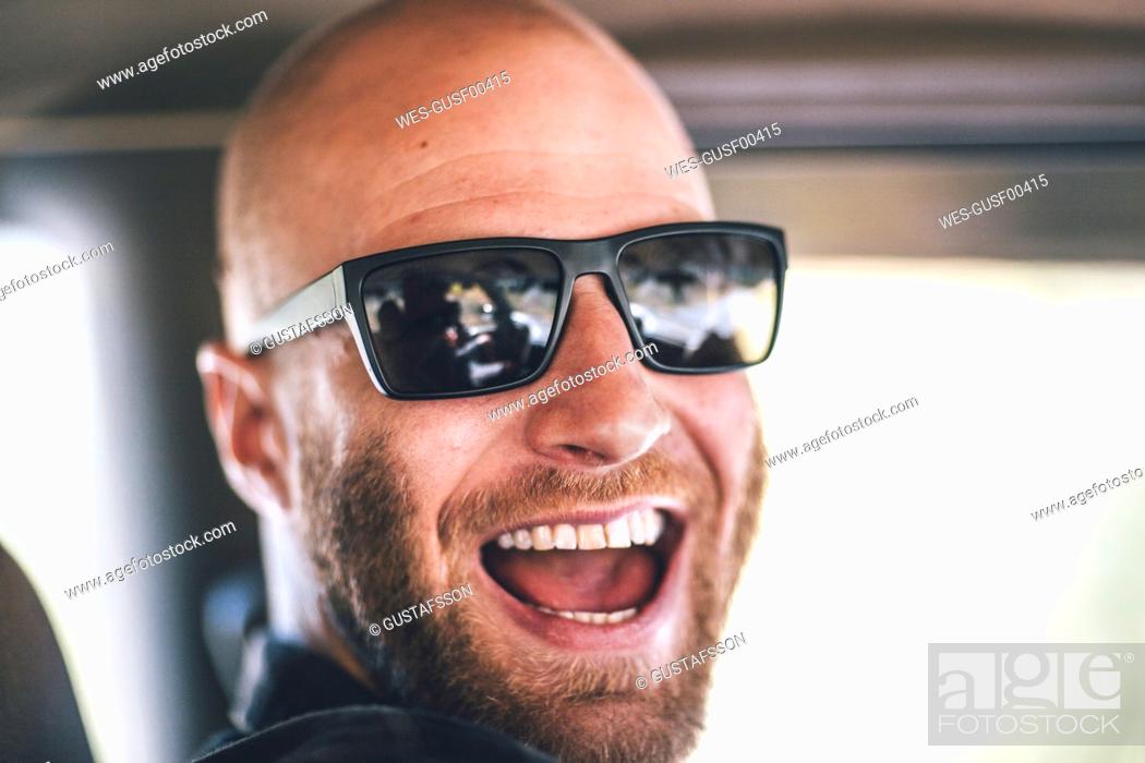Stock Photo: Portrait of happy young man with sunglasses and beard on a road trip.